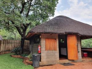 a small hut with a thatched roof at Inkonka Game farm in Uitsig