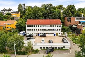 an aerial view of a white building with a parking lot at The Cozy Oslo Stay in Oslo