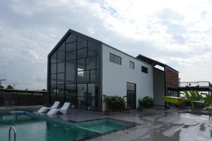 a house with a swimming pool in front of a building at The Occassia in Hyderabad +8 photos