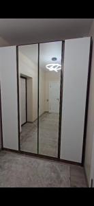 a large mirror in a room with a hallway at Апартамент in Osh +1 photo