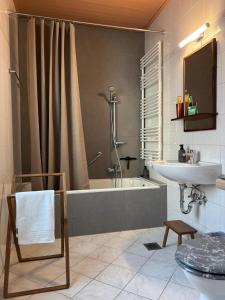 a bathroom with a bath tub and a sink at Holistic Home Ökologisch-Biologisch-Philosophisch in Höhr-Grenzhausen