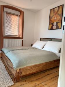 a bedroom with a bed with a wooden floor at Holistic Home Ökologisch-Biologisch-Philosophisch in Höhr-Grenzhausen +12 photos