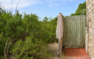a wooden fence with a towel hanging on it at Melkkamer Foremans Cottage in De Hoop Nature Reserve