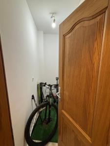 a bike parked in a room next to a door at Apartments Tibra in Sarajevo