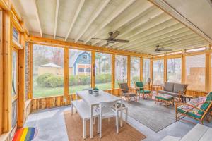 a screened in porch with a table and chairs at Experience lakeside tranquility at The 9 in Douglas