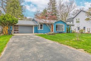 a home with a blue house and a driveway at Experience lakeside tranquility at The 9 in Douglas