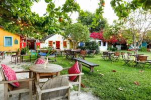 a group of tables and chairs in a yard at Casa da Cristina in Trancoso