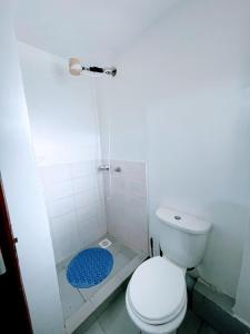 a white bathroom with a toilet and a shower at Elegant One Bedroom Apartment - Athi River - Kesit Anga in Athi River +19 photos