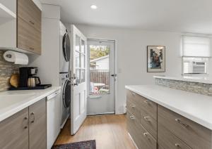 a kitchen with white cabinets and a counter top at 30 Day Rental - Walking Distance to Grand Haven in Grand Haven +15 photos