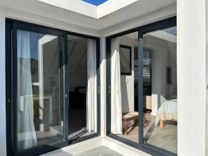 a room with sliding glass doors in a house at 35 On the Run in St Francis Bay