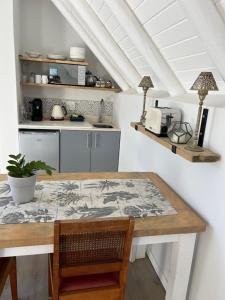 a kitchen with a wooden table and a counter at 35 On the Run in St Francis Bay +14 photos