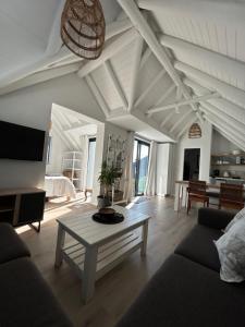 a living room with a couch and a table at 35 On the Run in St Francis Bay