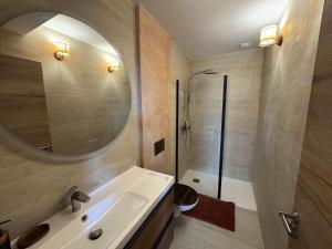 a bathroom with a sink and a mirror and a shower at Terrasse de Cimiez in Nice