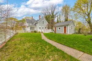 a white house with a yard and a fence at Elsie in Benton Harbor