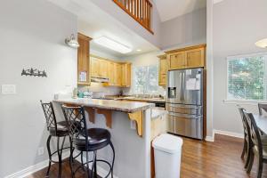 a kitchen with wooden cabinets and stainless steel appliances at SkyNest in Running Springs