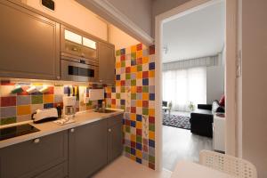 a kitchen with colorful tiles on the wall at Monroe Central Budapest in Budapest