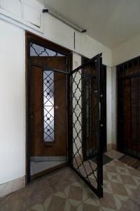 an open door with a wrought iron gate at Monroe Central Budapest in Budapest