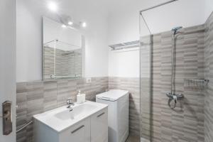 a bathroom with a toilet and a sink and a shower at Apto Beach View Playa los Cristiano in Arona