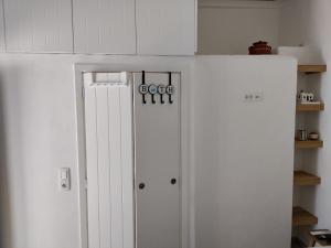 a white refrigerator freezer sitting in a kitchen at Armiriki Seaside in Kamares