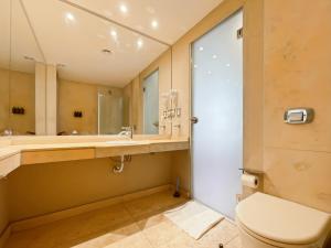 a bathroom with a toilet and a sink at Ayres Suites Cochabamba in Buenos Aires +41 photos