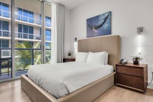 a bedroom with a large bed and a large window at Condo with 1 Bedroom Terrace and Hot Tub in Hollywood