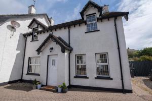 a white house with at Corner Cottage in Castlerock