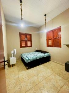a bedroom with a bed in a room at Jfhouse beach in Cascavel +16 photos