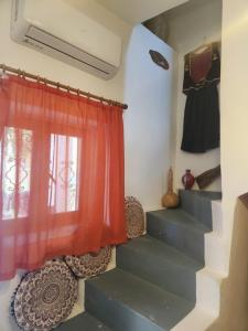 a staircase with a red curtain and a window at Casa Di Mama in Valaneíon