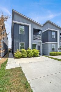 a large house with a driveway at Spacious 3BR Home w Yard, Smart TV Parking in Humble