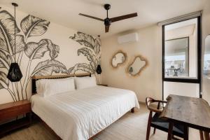 a bedroom with a bed and a wall with plants at Itzel Samsara Dream Penthouse in Tulum +25 photos