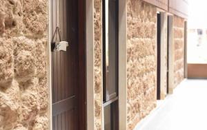 an open door with a window in a brick wall at New Moon Duplex Studio in Batroun Souk in Batroûn