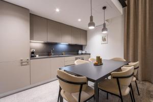 a kitchen and dining room with a table and chairs at Old Theatre Suites - Capri in Valletta