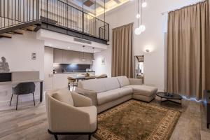 a living room with a couch and a table at Old Theatre Suites - Capri in Valletta