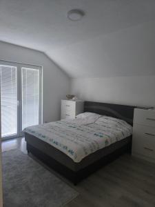 a white bedroom with a bed and two windows at Vila Đul in Konjic +30 photos