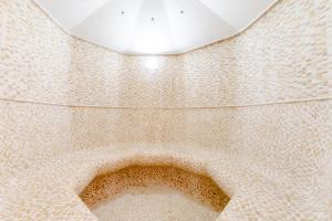 a bathroom with a tiled floor with a toilet at Hotel Relais Vecchio Maso in Trento +33 photos