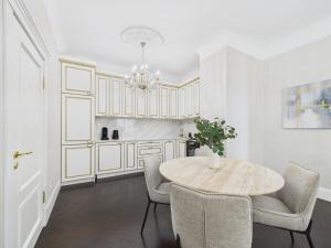 a dining room with a table and chairs at Vāgnera Rezidence in Rīga