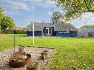 a blue house with a yard with a yard at Spacious Retreat in Skovmose-By Traum in Neder Lysabild +39 photos