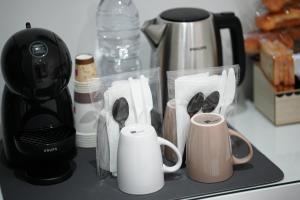 a kitchen counter with a coffee maker and coffee cups at Argentium Rooms in Arienzo San Felice