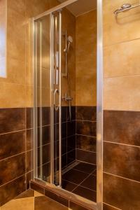 a shower with a glass door in a bathroom at Old Town Church Bells in Kotor