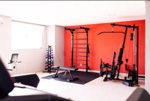 a room with a gym with two tread machines at Perfect Campolim loft in Sorocaba