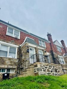 a brick house with a staircase in front of it at Cozy Drexel Hill Retreat - Perfect for Families in Drexel Hill
