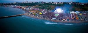 Una gran multitud de personas en una playa durante el estival. en Charming flat near Black Sea, en Constanţa
