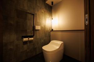 a bathroom with a toilet with a light on the wall at Pino-富士山麓-山中湖-新築貸切ヴィラ-蚊帳東屋BBQ無料-150平米ドッグラン付-小型犬3匹無料-長期滞在早期歓迎割引-バリアフリー in Yamanakako