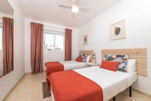 a bedroom with two beds and a window at Profithome- Brisas de Güimar in Puertito de Güímar +16 photos