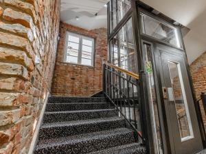 a staircase in a brick building with a door at Liberum Residence Old Town in Gdańsk