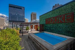 a building with a swimming pool on the side of it at Brand new, luxury, wifi, pool with 24hr security in Cape Town
