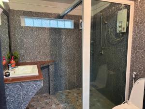 a bathroom with a shower and a sink at ColYve Siem Reap in Phum Pobos