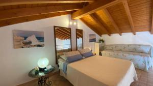 a bedroom with a bed and a chair in a room at Celi Blu Apartments in Lizzanello