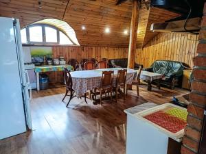 a kitchen and dining room with a table and chairs at Willa Mortęgi in Lubawa