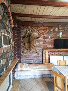 a brick wall with a statue of a bear on it at Willa Mortęgi in Lubawa